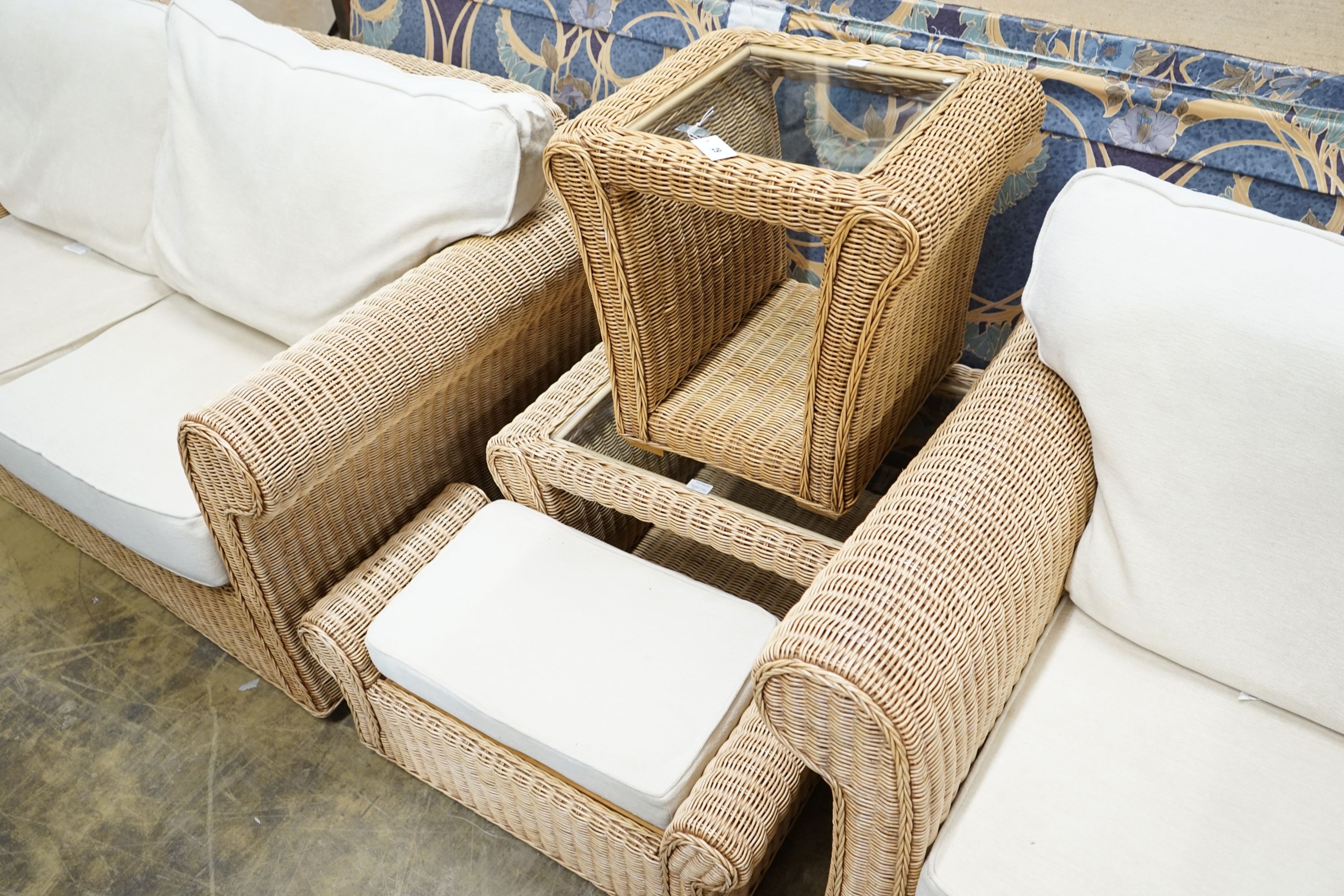 A rattan conservatory suite comprising two seater settee, length 180cm, depth 85cm, height 184cm, armchair, footstool and two glass topped tables